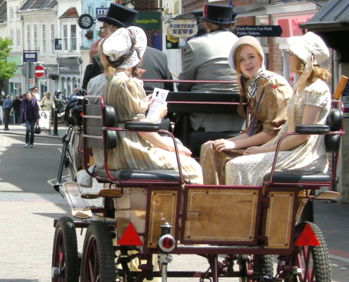 4 girls in bonnets and two drives in top hats during carriage ride during Jane Austen Alton Regency Day