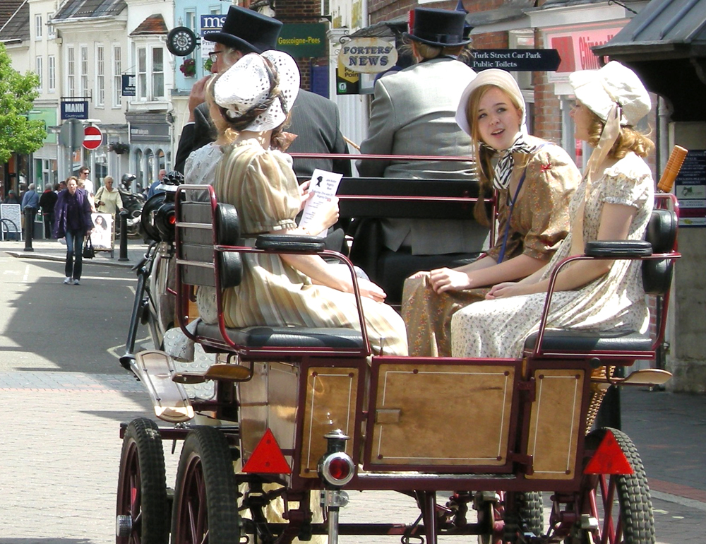 4 girls in bonnets and two drives in top hats during carriage ride during Jane Austen Alton Regency Day