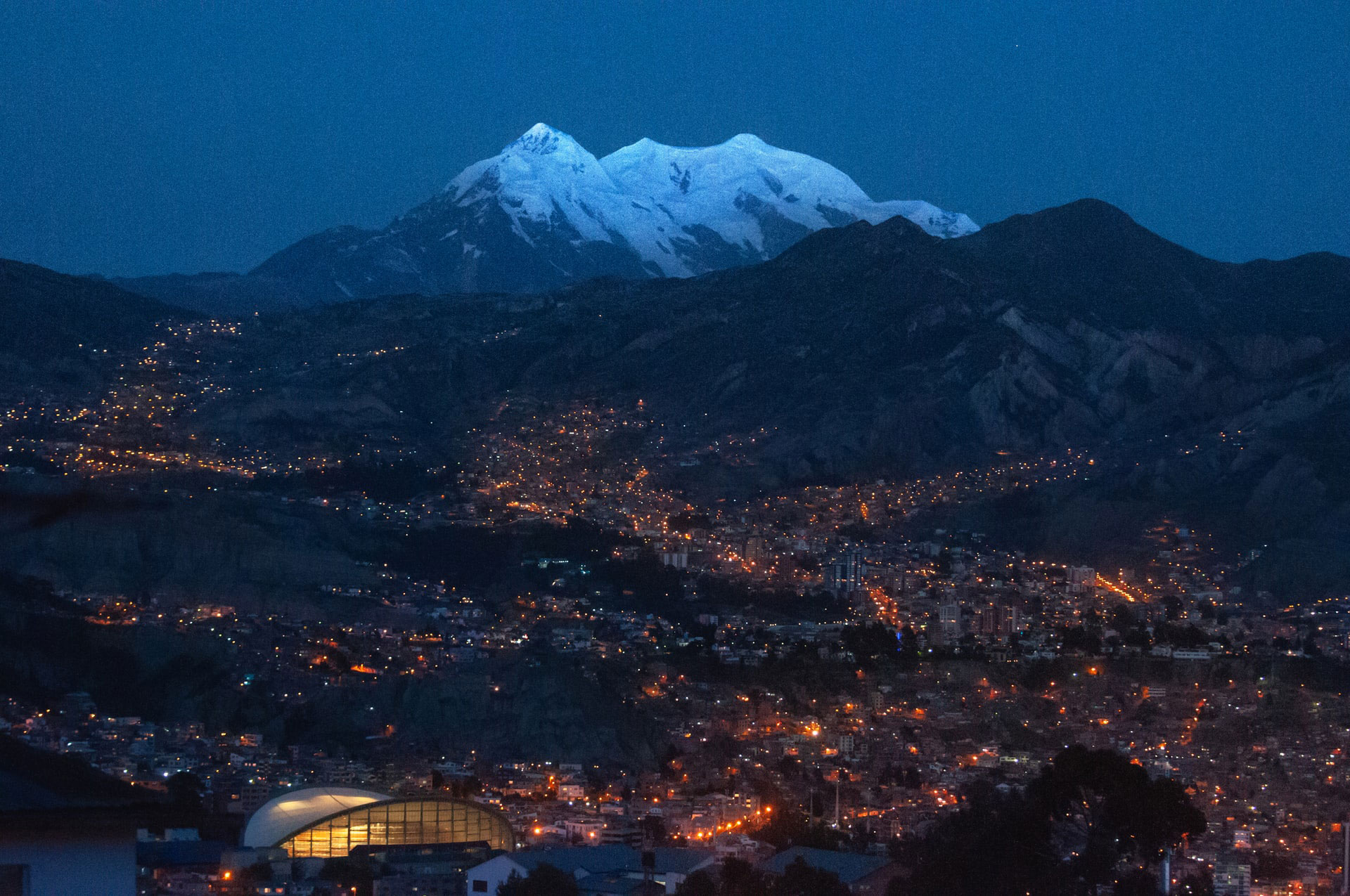 snow covered mountain over city at night in Bolivia