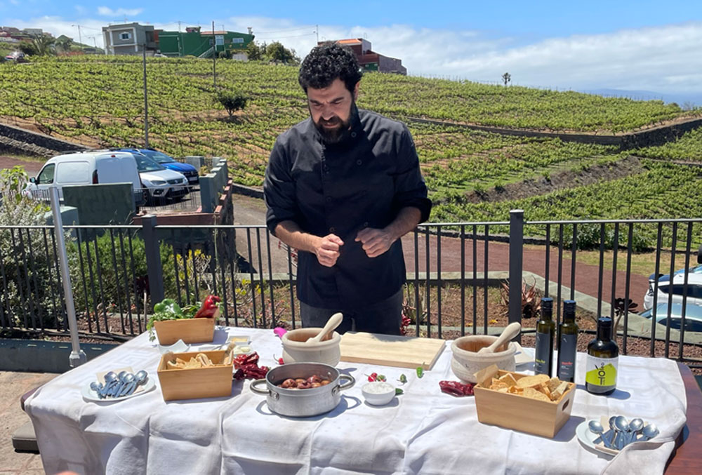  chef dressed in black prepares a taste of Tenerife.