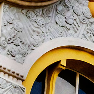 close up of Art Deco fruits and flowers in a cement frieze