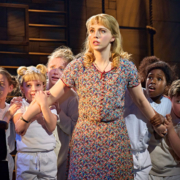 Eve Norris as Miss Honey and children of the ensemble.