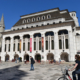 guildhall art gallery, a modern gothic style building in The City of London. Blue skies and wide plaza.