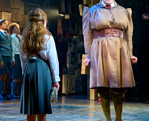 Miss Trunbull, Matilda's evil headmistress, is played by a man in true Panto dame fashion. Here she and the rebellious Matilda have a face off.